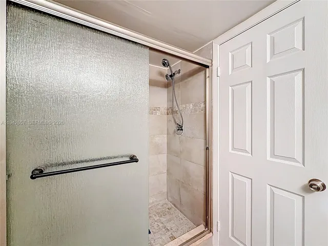 a view of an empty room and chandelier fan
