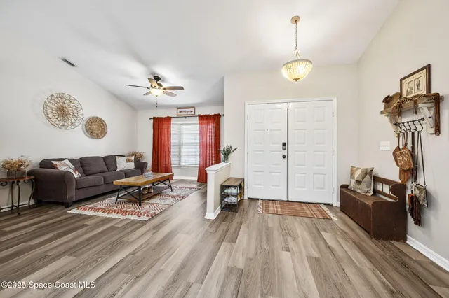 a living room with furniture a flat screen tv and a window