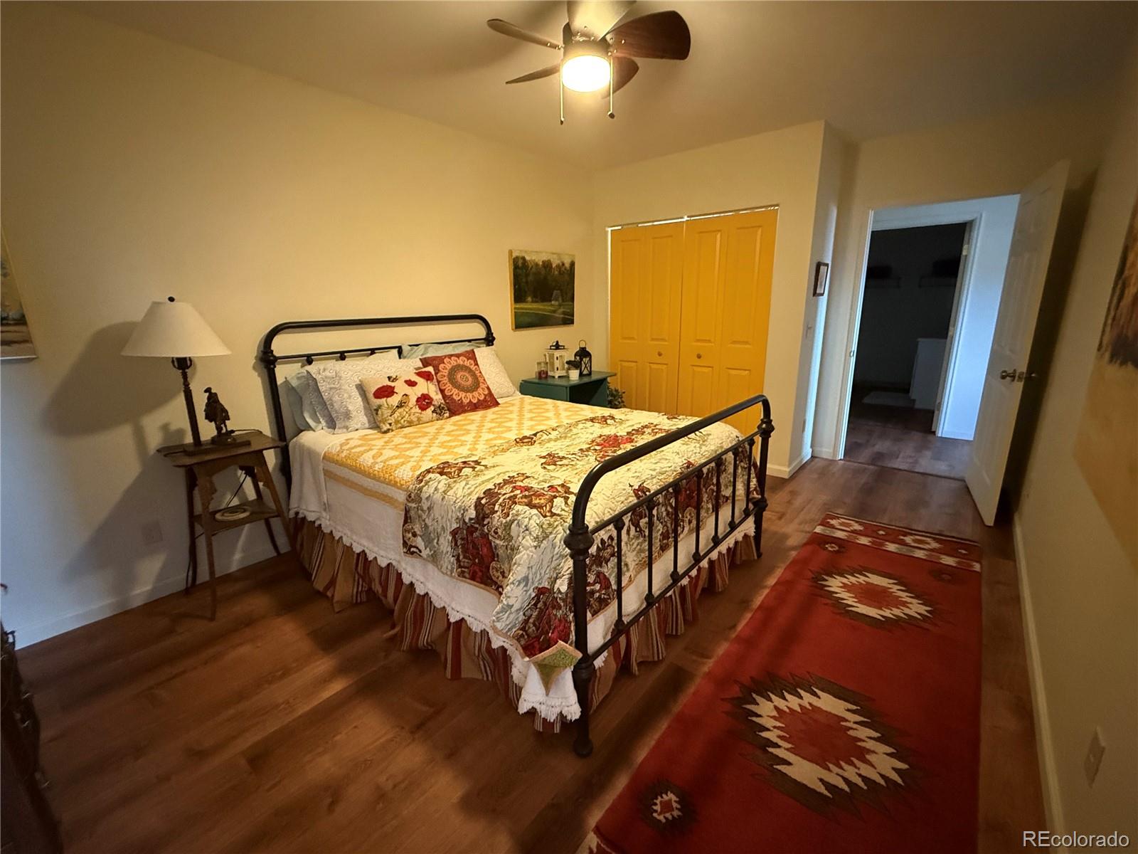 406-449 Schierl Road Fort Garland, CO 81133 - Photo 20 of 50 a bedroom with a bed a lamp and a flat screen tv