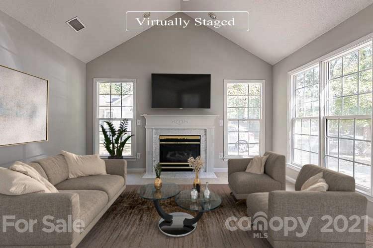 1323 Tucker Road Monroe, NC 28110 - Photo 2 of 17 a living room with furniture a flat screen tv and a fireplace