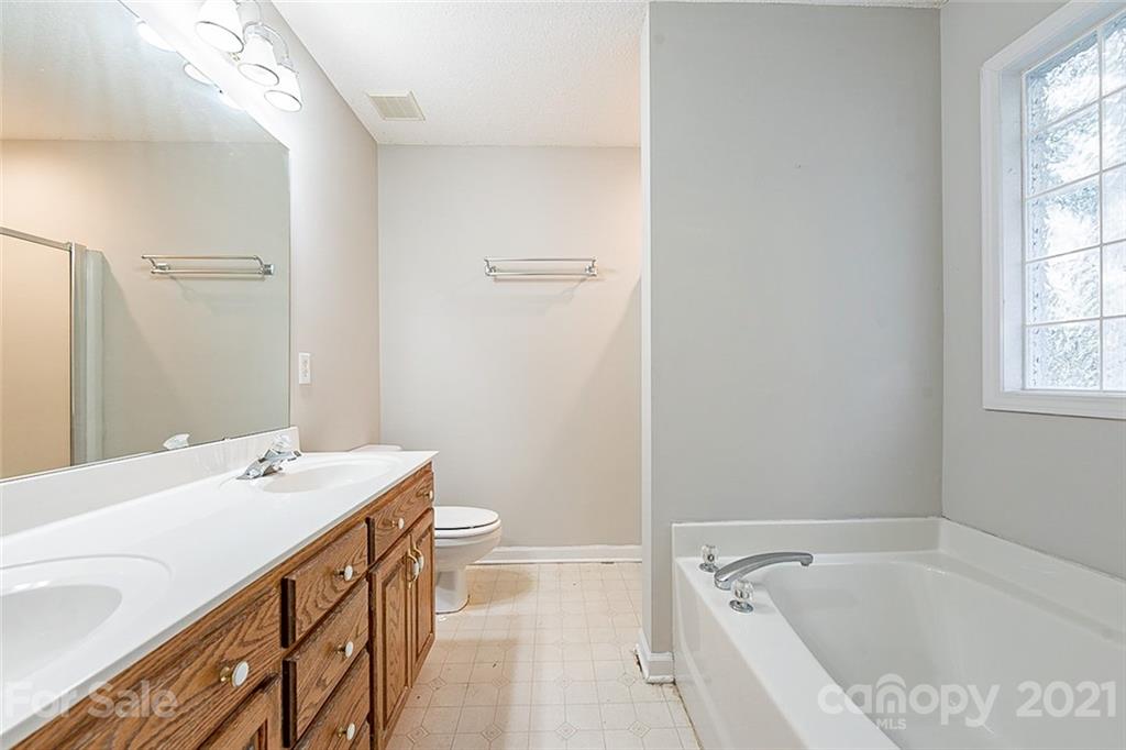 1323 Tucker Road Monroe, NC 28110 - Photo 13 of 17 a bathroom with a tub sink and mirror