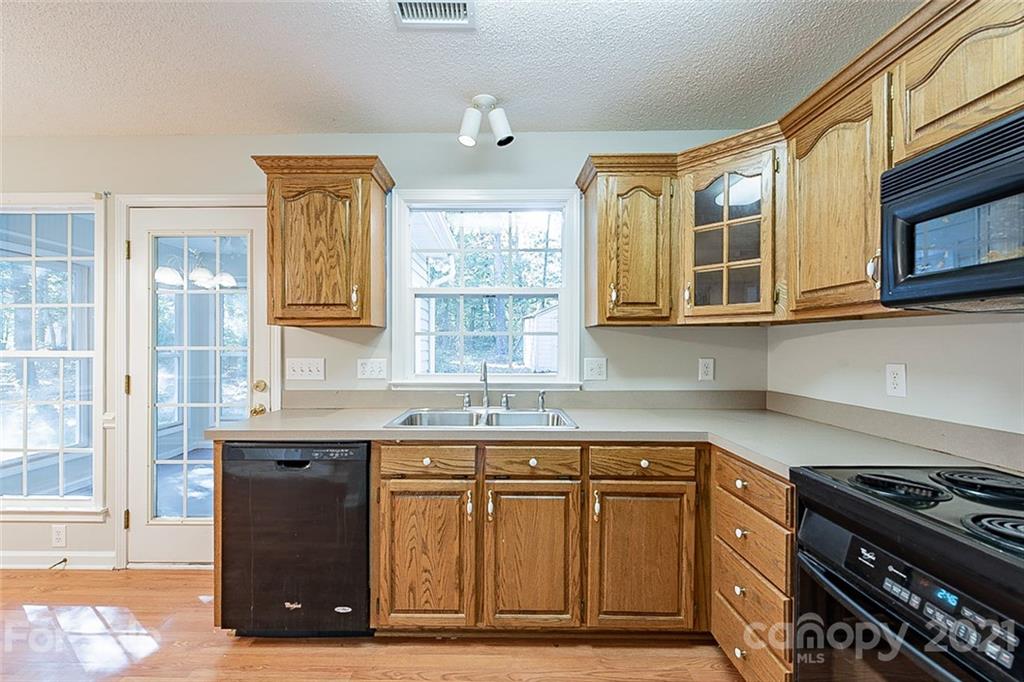1323 Tucker Road Monroe, NC 28110 - Photo 5 of 17 a kitchen with stainless steel appliances granite countertop a stove a sink and a microwave