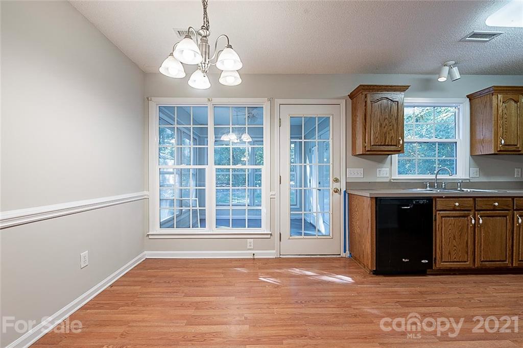 1323 Tucker Road Monroe, NC 28110 - Photo 6 of 17 a view of a kitchen with granite countertop cabinets and a wooden floor