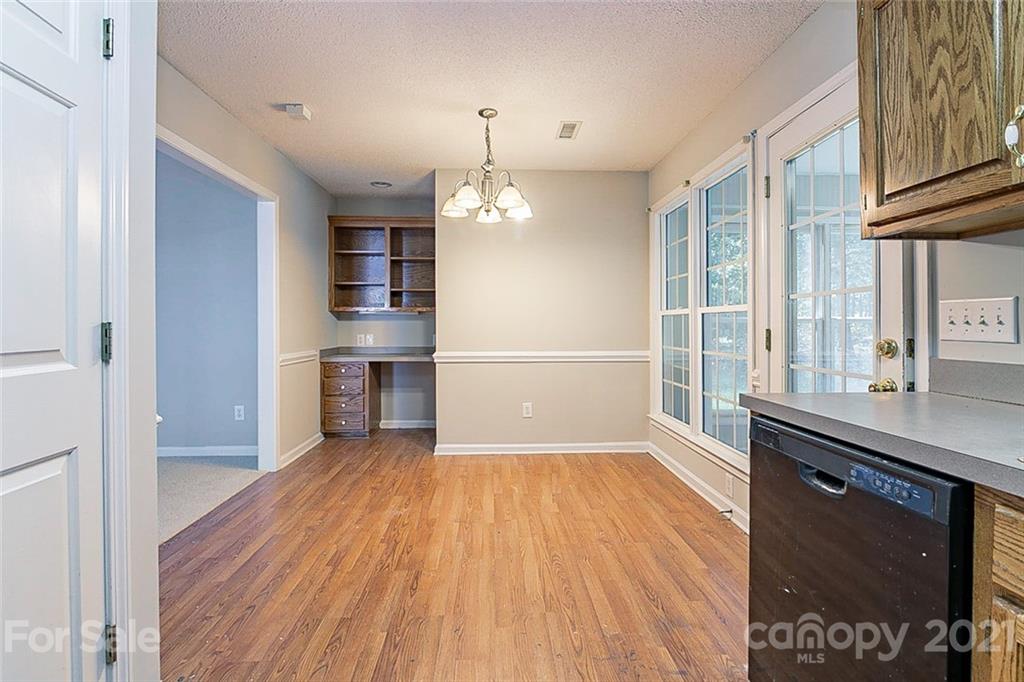 1323 Tucker Road Monroe, NC 28110 - Photo 7 of 17 a view of a kitchen with wooden floor and a window