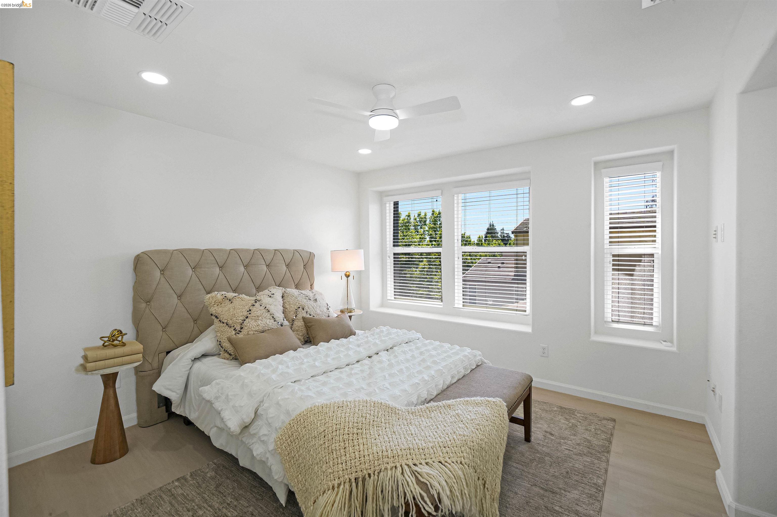 449 Constantine Court San Ramon, CA 94583 - Photo 41 of 63 Bright bedroom featuring multiple windows with blinds, recessed lighting, a ceiling fan, and light wood-finish flooring