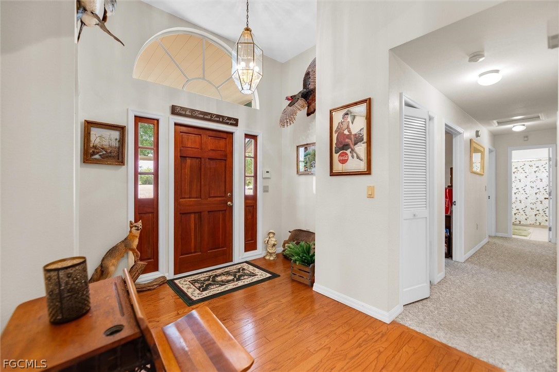 5997 Dragoon Court Fort Denaud, FL 33935 - Photo 11 of 49 a bedroom with a bed and a chandelier