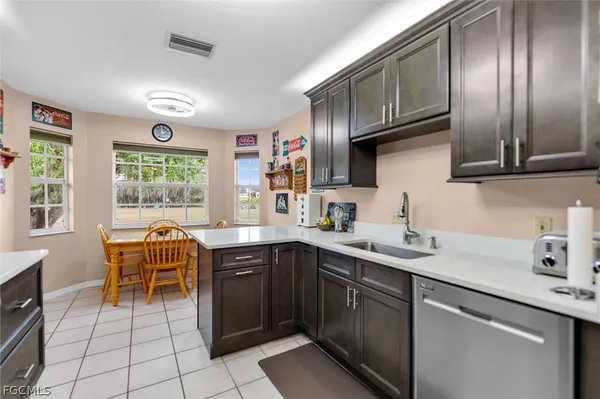 a kitchen with a sink a stove and cabinets