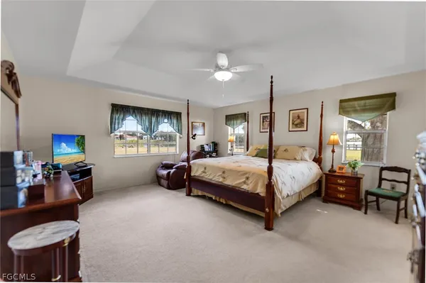 a spacious bedroom with a bed and furniture