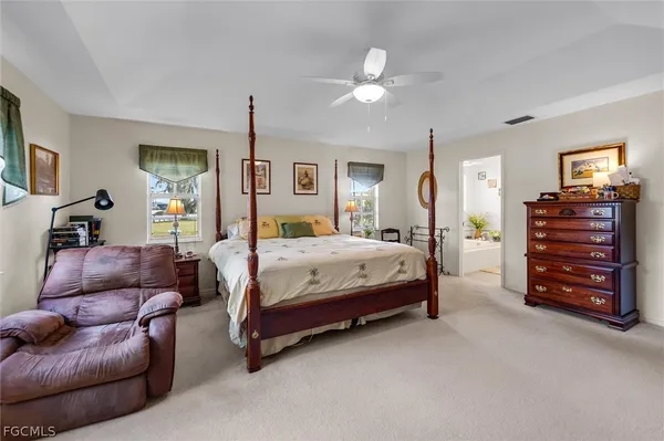 a spacious bedroom with a bed and furniture