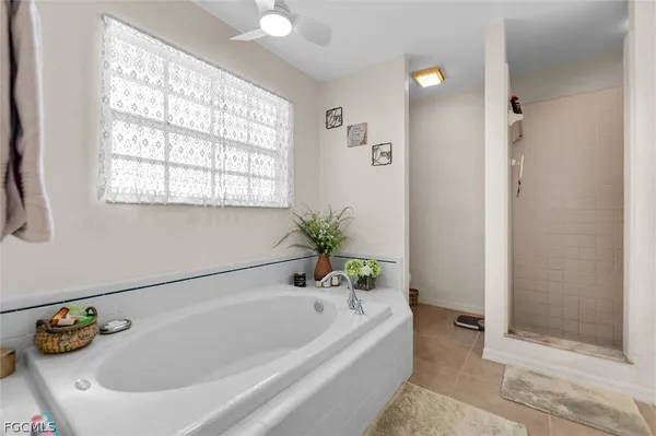 a white bath tub sitting next to a window
