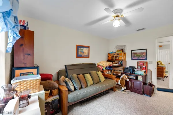 a living room with furniture and a lamp