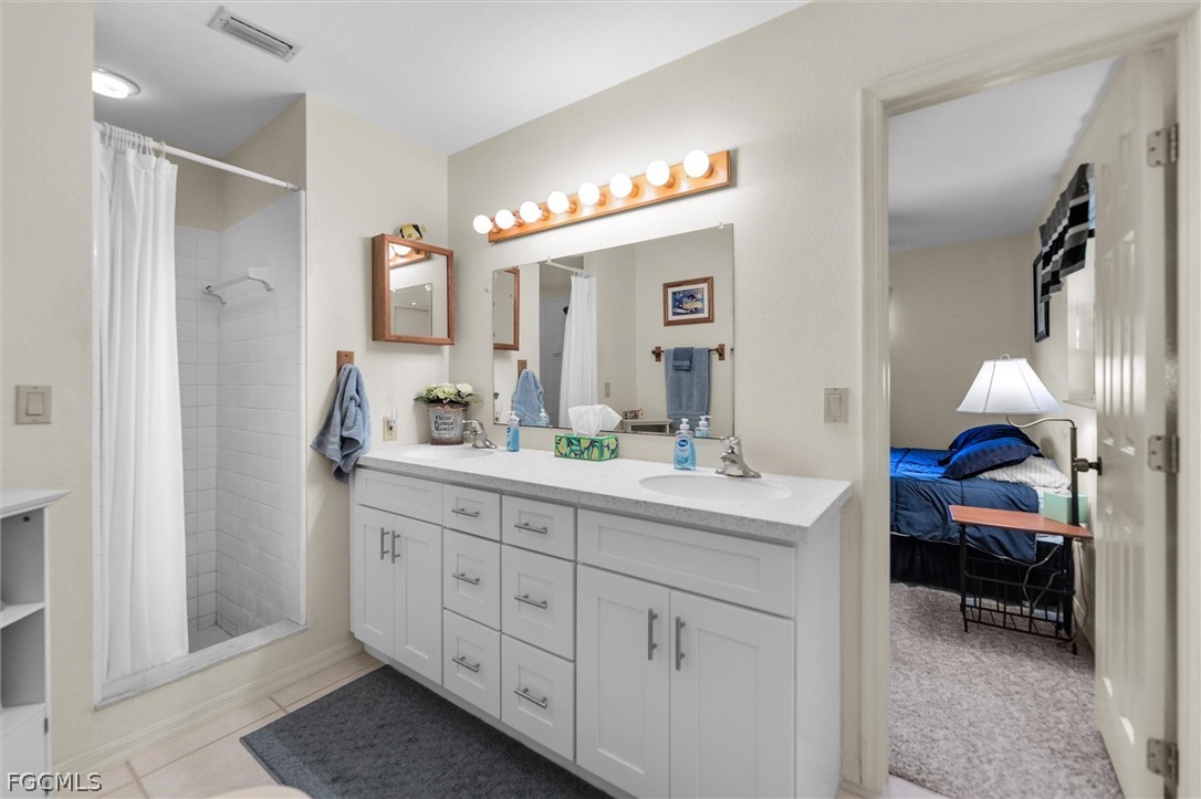 5997 Dragoon Court Fort Denaud, FL 33935 - Photo 28 of 49 a en suite bathroom with double sink and a mirror