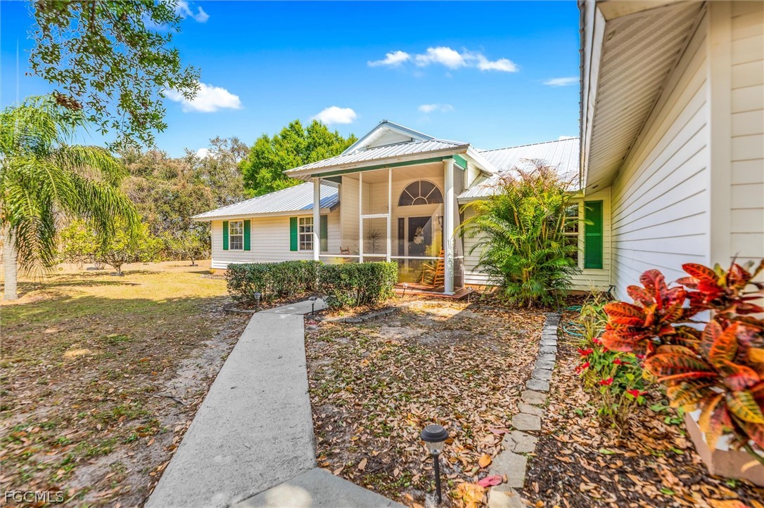 5997 Dragoon Court Fort Denaud, FL 33935 - Photo 6 of 49 a front view of a house with garden
