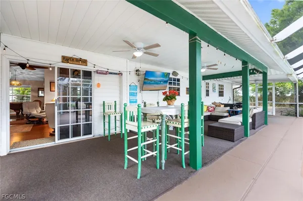 a view of a porch with chairs and a table