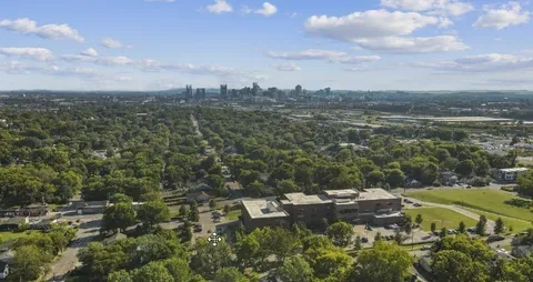 an aerial view of residential house with parking and yard
