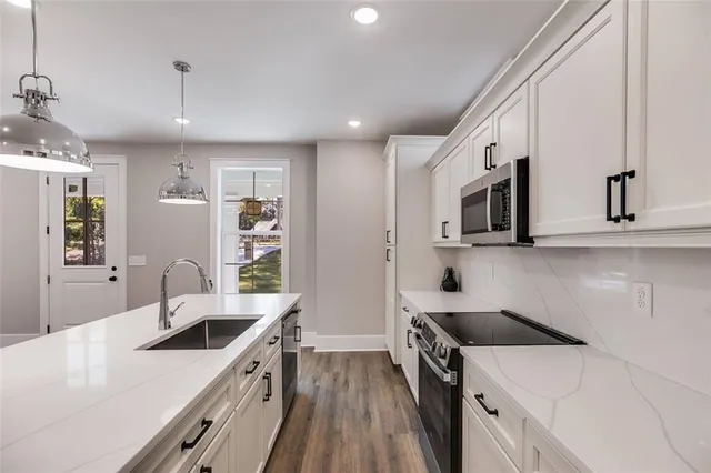 a view of a kitchen counter a sink and dishwasher with wooden floor