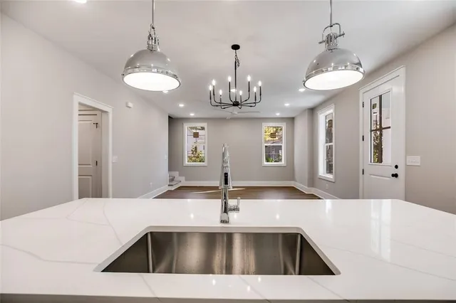 a living room with furniture kitchen and a chandelier