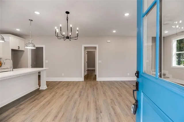 a view of a kitchen with wooden floor and a sink