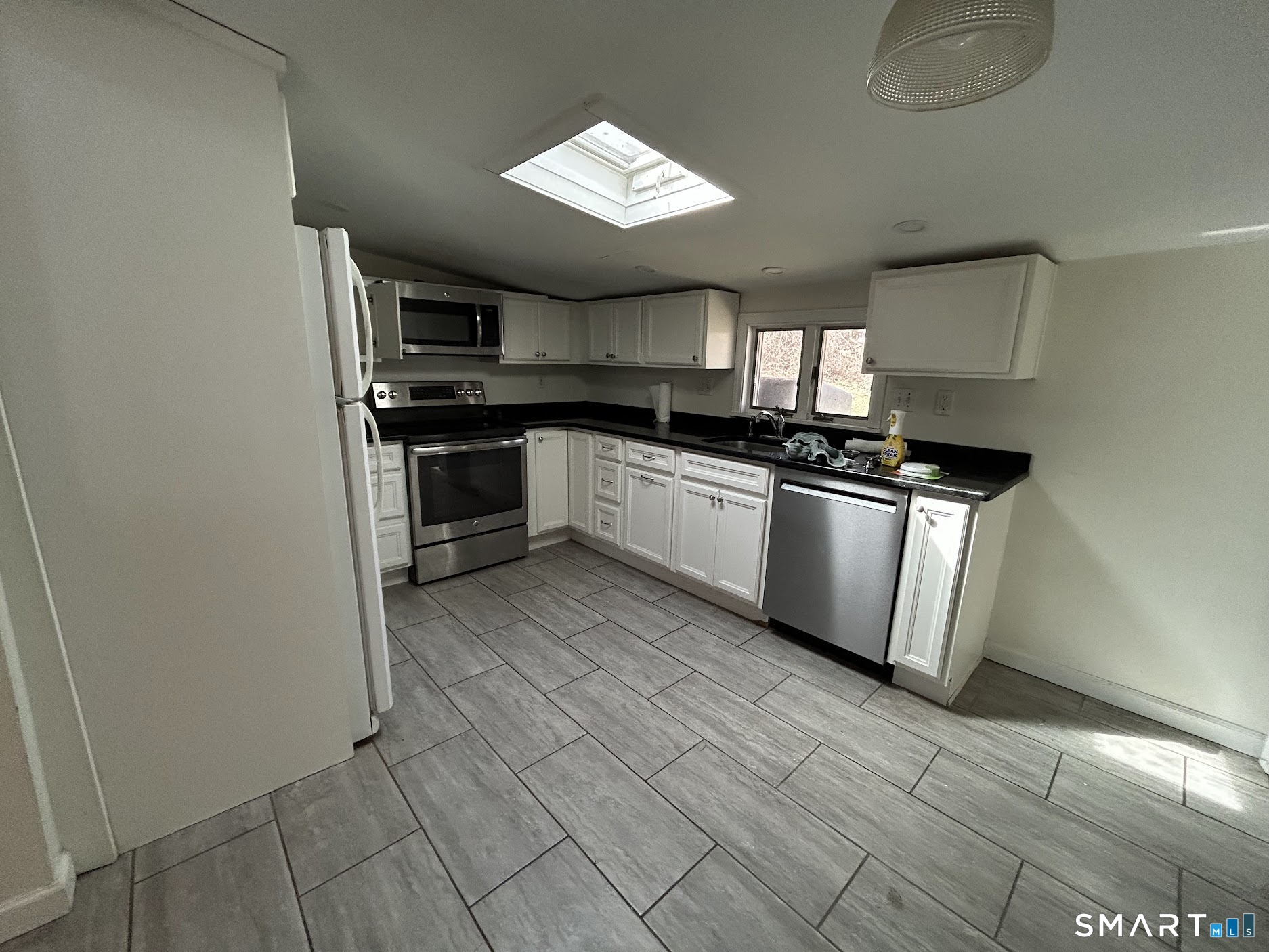 236 Wire Mill Road Stamford, CT 06903 - Photo 5 of 11 a kitchen with granite countertop a sink cabinets and stainless steel appliances