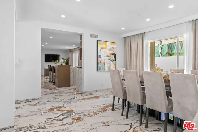 a kitchen with counter top space dining table and chairs