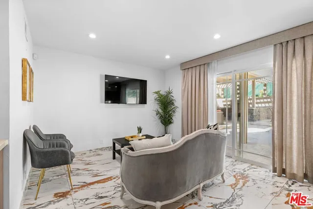 a bathroom with a granite countertop sink a mirror and a shower