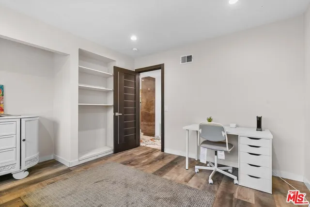 a bedroom with a bed and a lamp