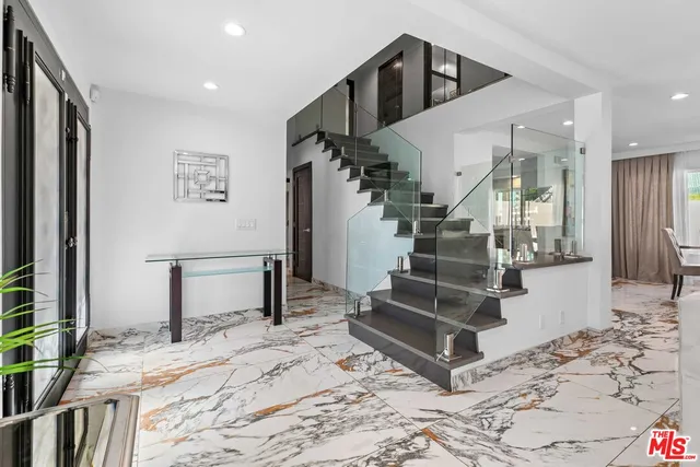 a bathroom with a granite countertop sink mirror and shower