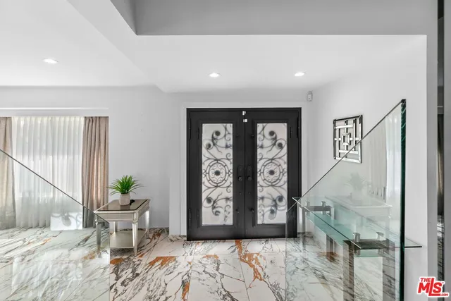 a spacious bedroom with a bed and a lamp