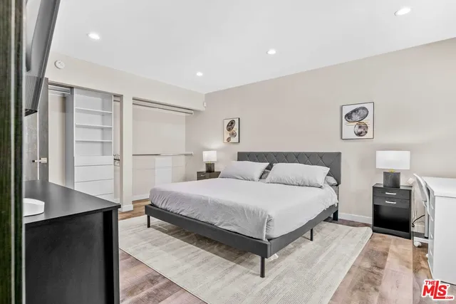 a bathroom with a granite countertop sink mirror vanity and toilet