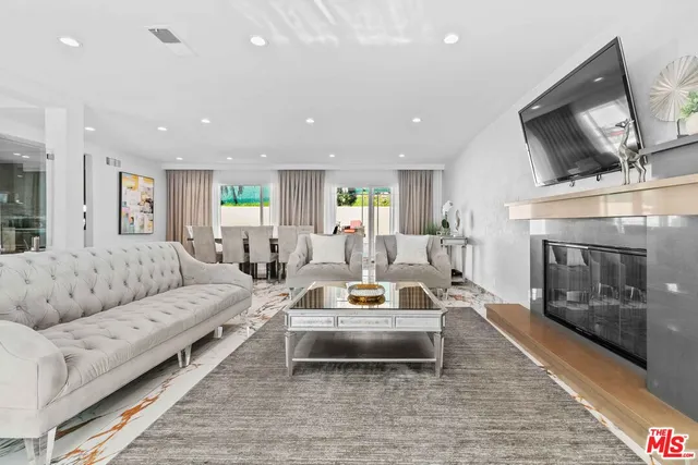 a living room with furniture fireplace and a fireplace