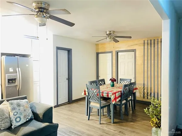 a dining room with furniture window and wooden floor