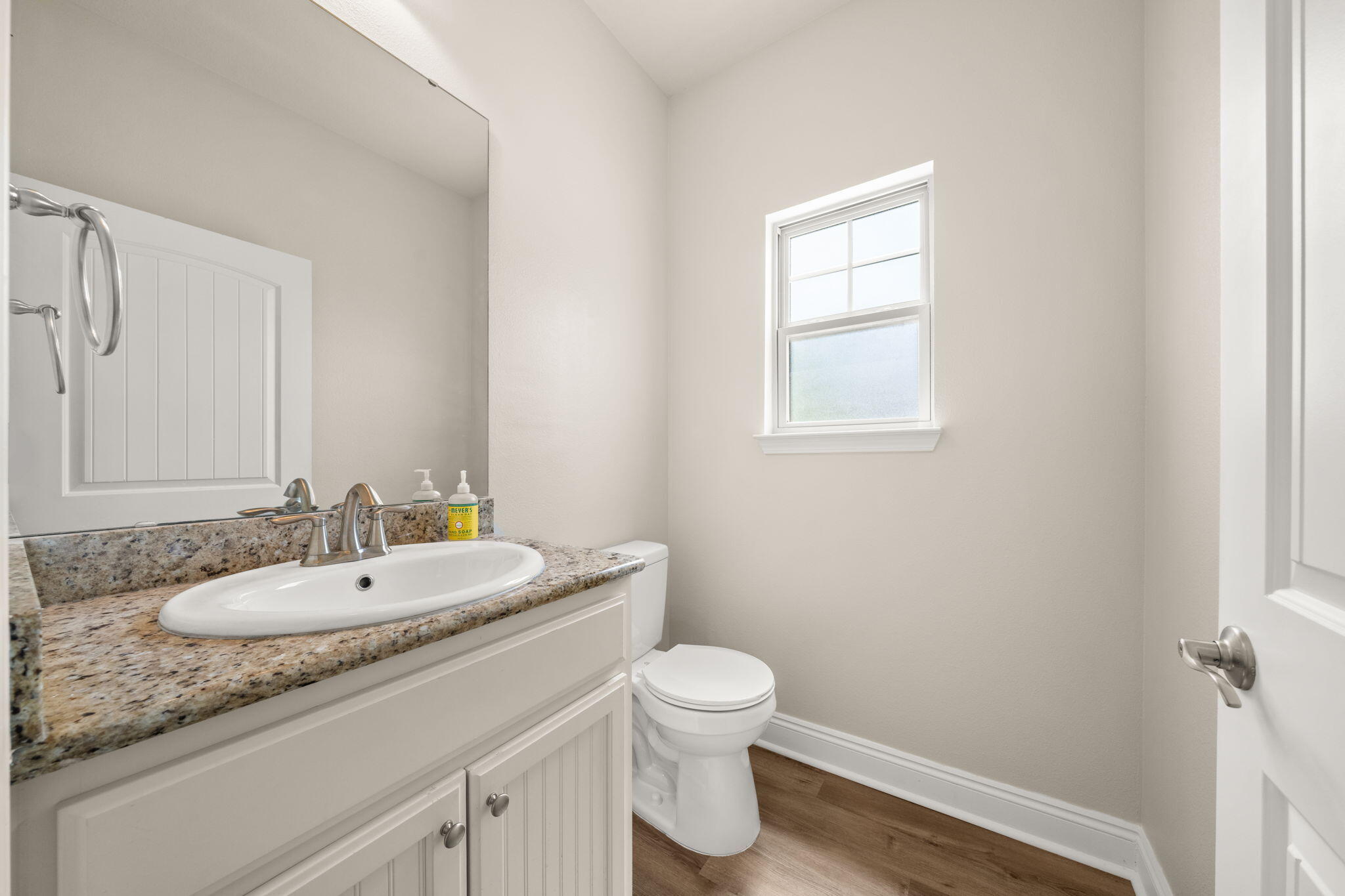 120 Brandywine Road Freeport, FL 32439 - Photo 14 of 55 a bathroom with a granite countertop sink toilet a large mirror and a window