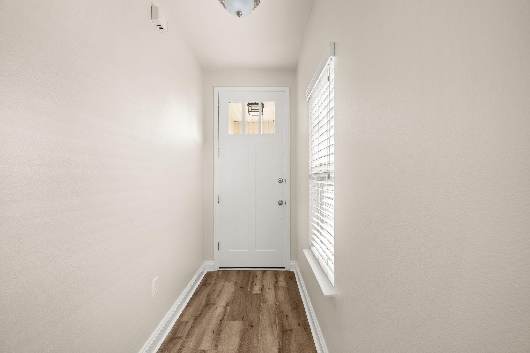 120 Brandywine Road Freeport, FL 32439 - Photo 4 of 55 a view of an empty room with wooden floor and a window