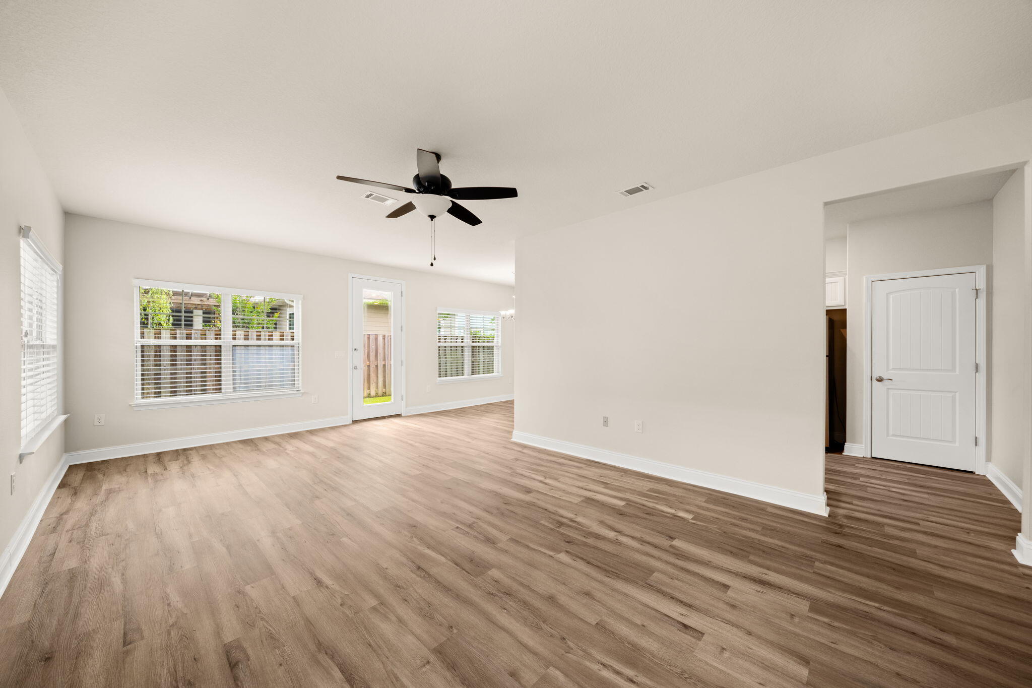 120 Brandywine Road Freeport, FL 32439 - Photo 6 of 55 a view of an empty room with wooden floor and a window