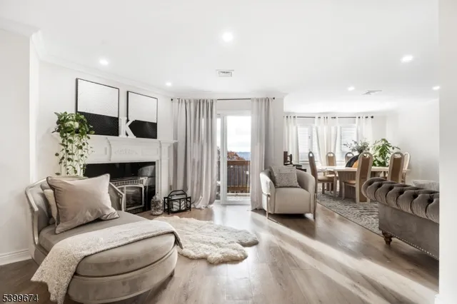 a bedroom with furniture a fireplace and potted plants