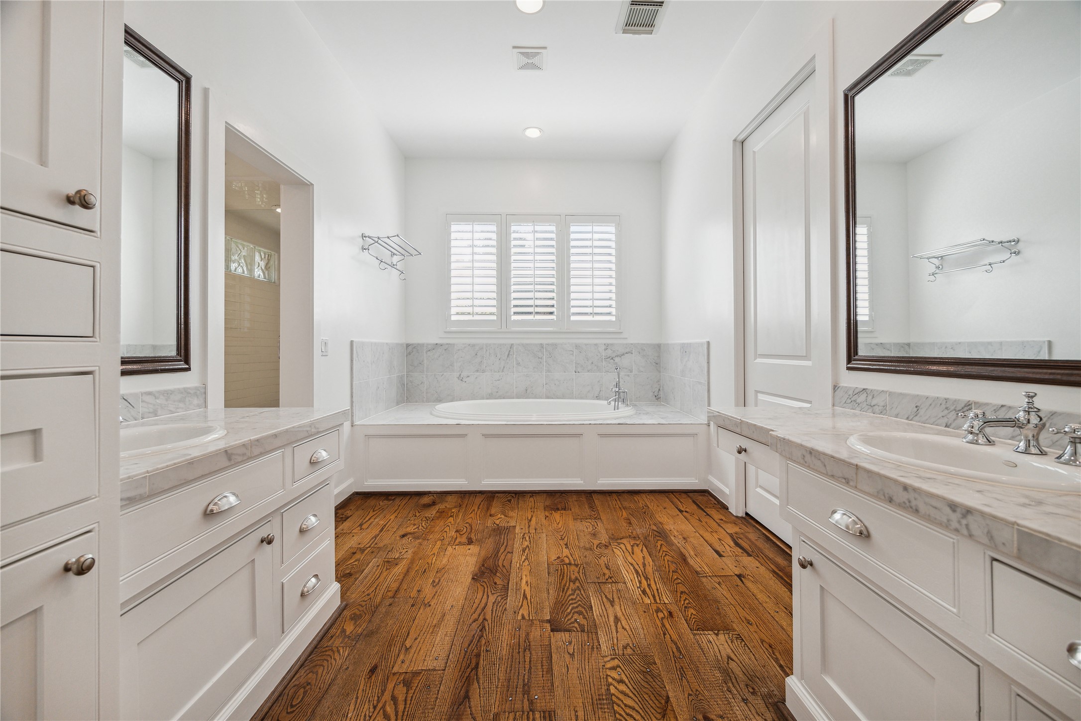 1238 West 22nd Street Houston, TX 77008 - Photo 16 of 43 Primary Bathroom (14x13) features double sinks by Kohler, marble countertops, plantation shutters, built-in hamper, soaking tub, and separate standing shower