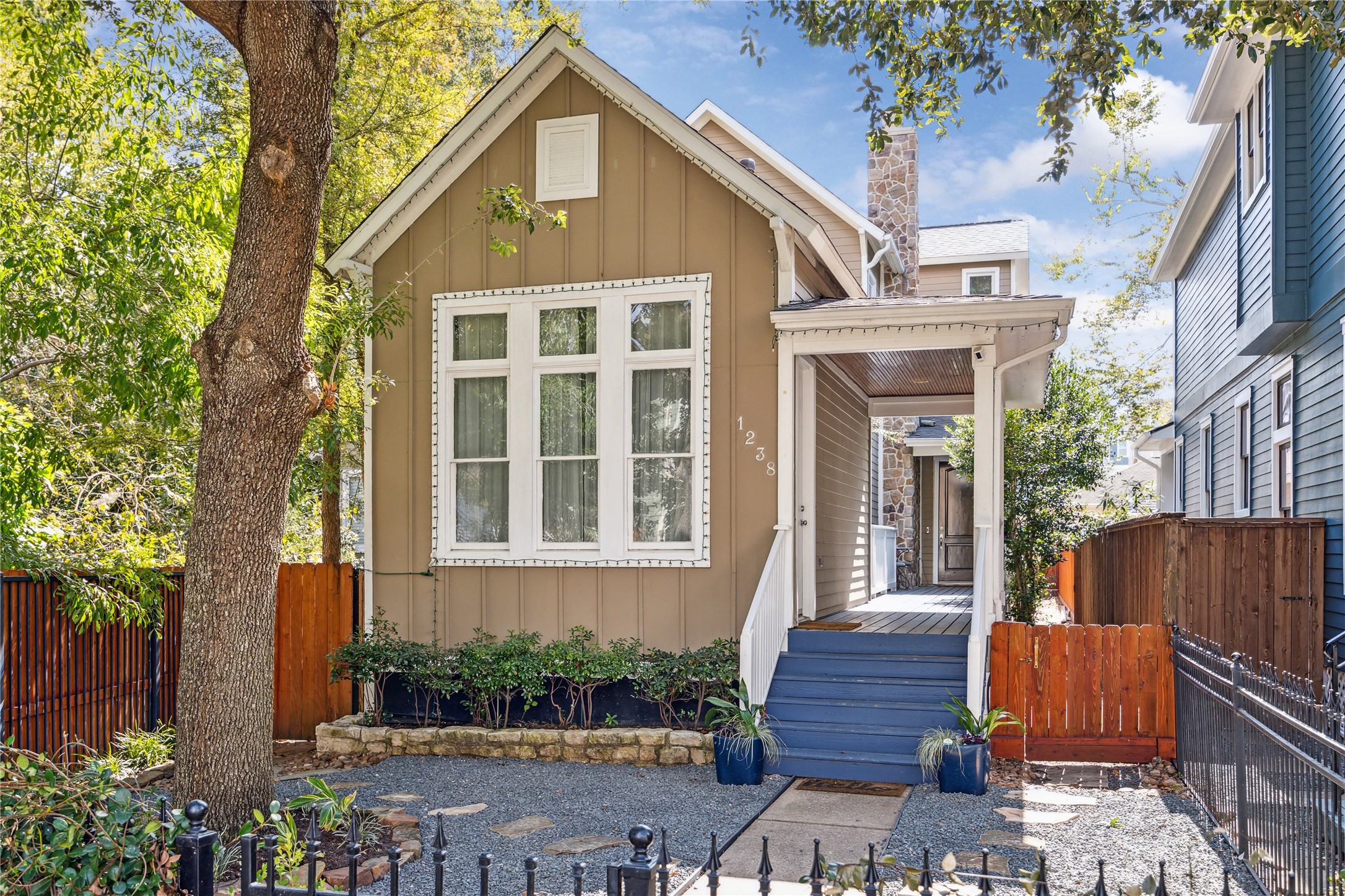 1238 West 22nd Street Houston, TX 77008 - Photo 34 of 43 Welcome to W 22nd! The house is an optical illusion. From the street the property looks tiny, but it’s one of the largest on the street. The structure to the left of the above-ground walkway is a 1 bedroom/1 bathroom separate casita and if you continue down the walkway to the brown wood front door, you will enter into the 3 bedroom/3.5 bathroom home.