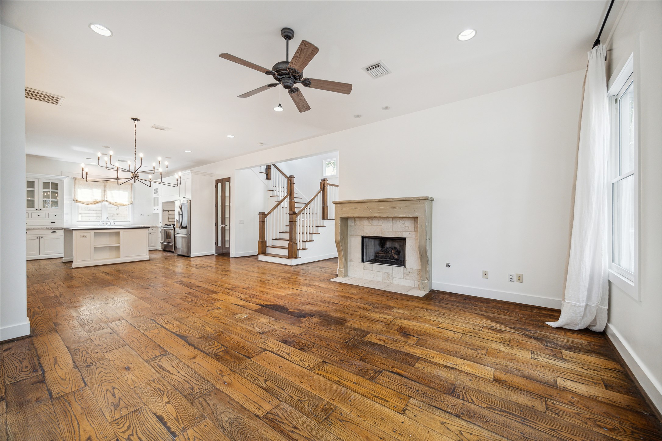1238 West 22nd Street Houston, TX 77008 - Photo 5 of 43 The whole house has natural, wide wood plank floor with the exception of the bathrooms, mudroom, and laundry room. The living room has a ceramic gas long fireplace. Drapes remain with the new owner.