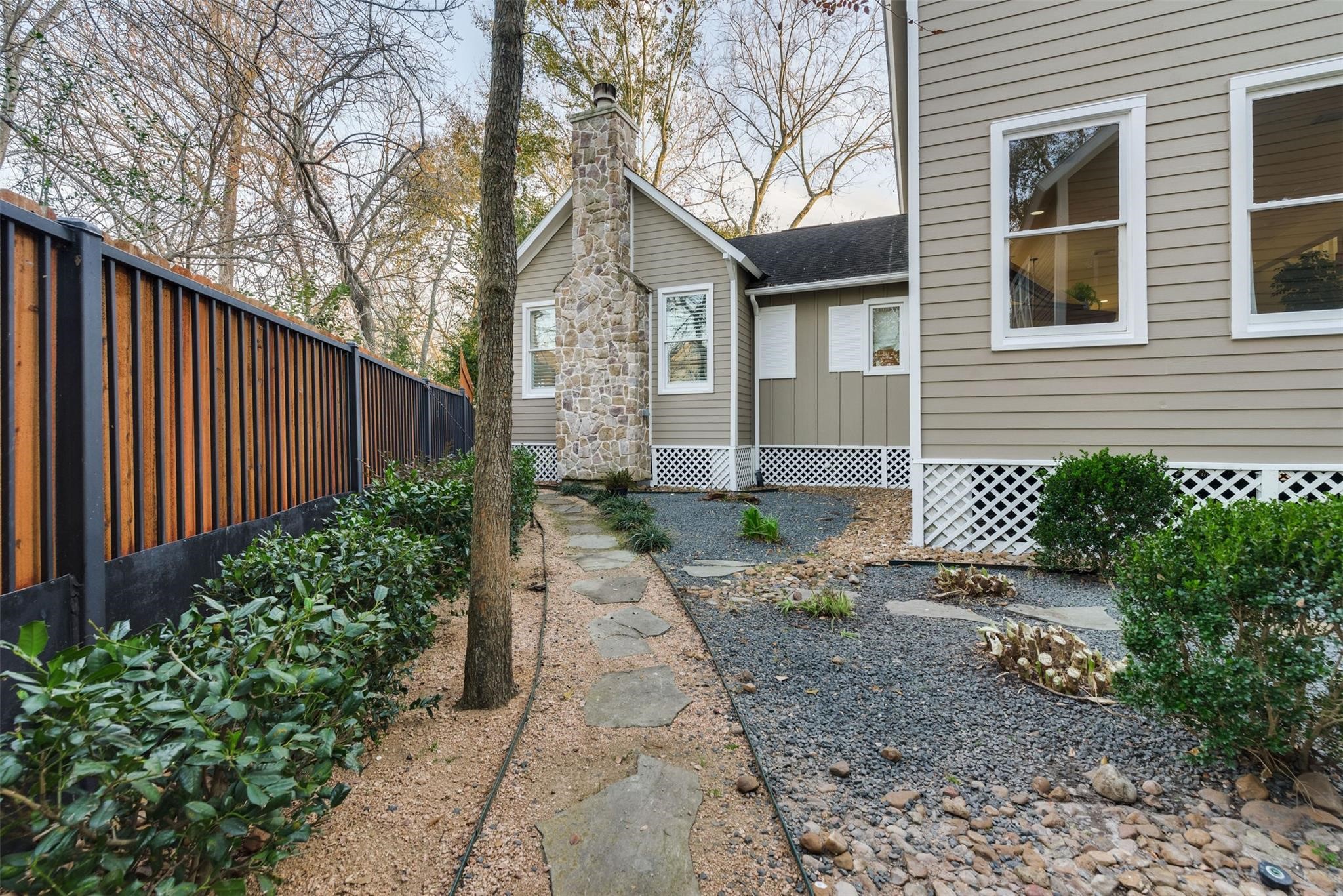 1238 West 22nd Street Houston, TX 77008 - Photo 9 of 43 Another view with a peak of the courtyard and the walking paths around the property. The exterior is a mix of stone and cement board.