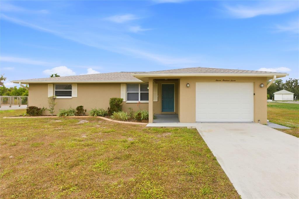 a view of a house with a yard and garage