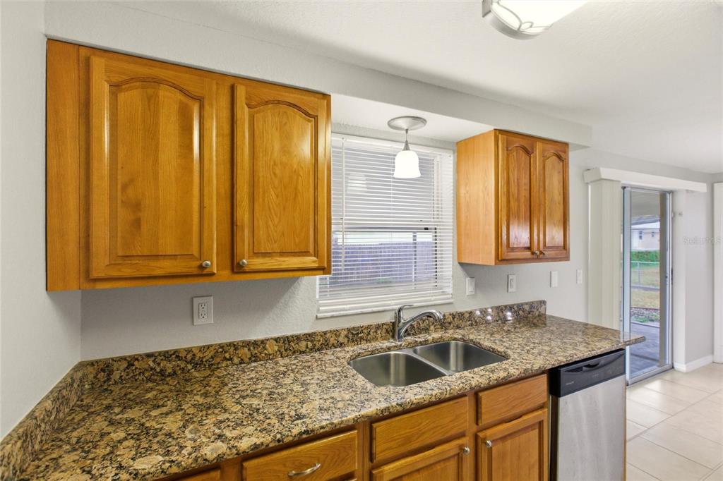 1107 Seneca Road Venice, FL 34293 - Photo 13 of 30 a kitchen with a sink and cabinets