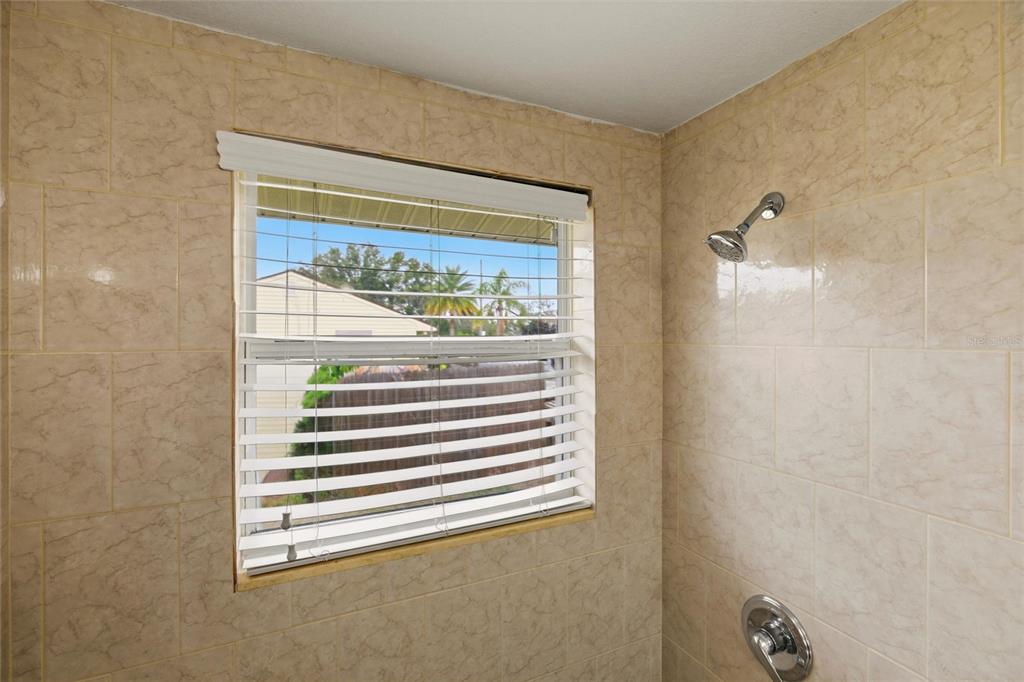 1107 Seneca Road Venice, FL 34293 - Photo 19 of 30 a bathroom with a shower and a window