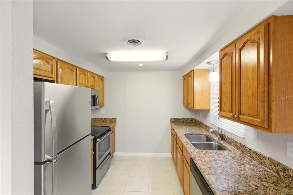 1107 Seneca Road Venice, FL 34293 - Photo 3 of 30 a kitchen with a refrigerator and a sink