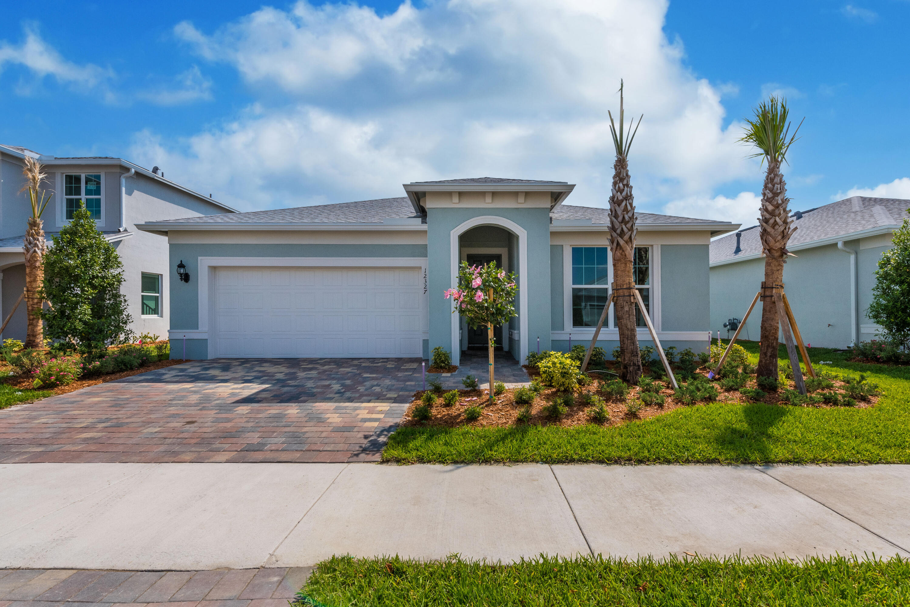 12327 Southwest Sand Dollar Way Port St. Lucie, FL 34987 - Photo 1 of 29 a front view of a house with garden