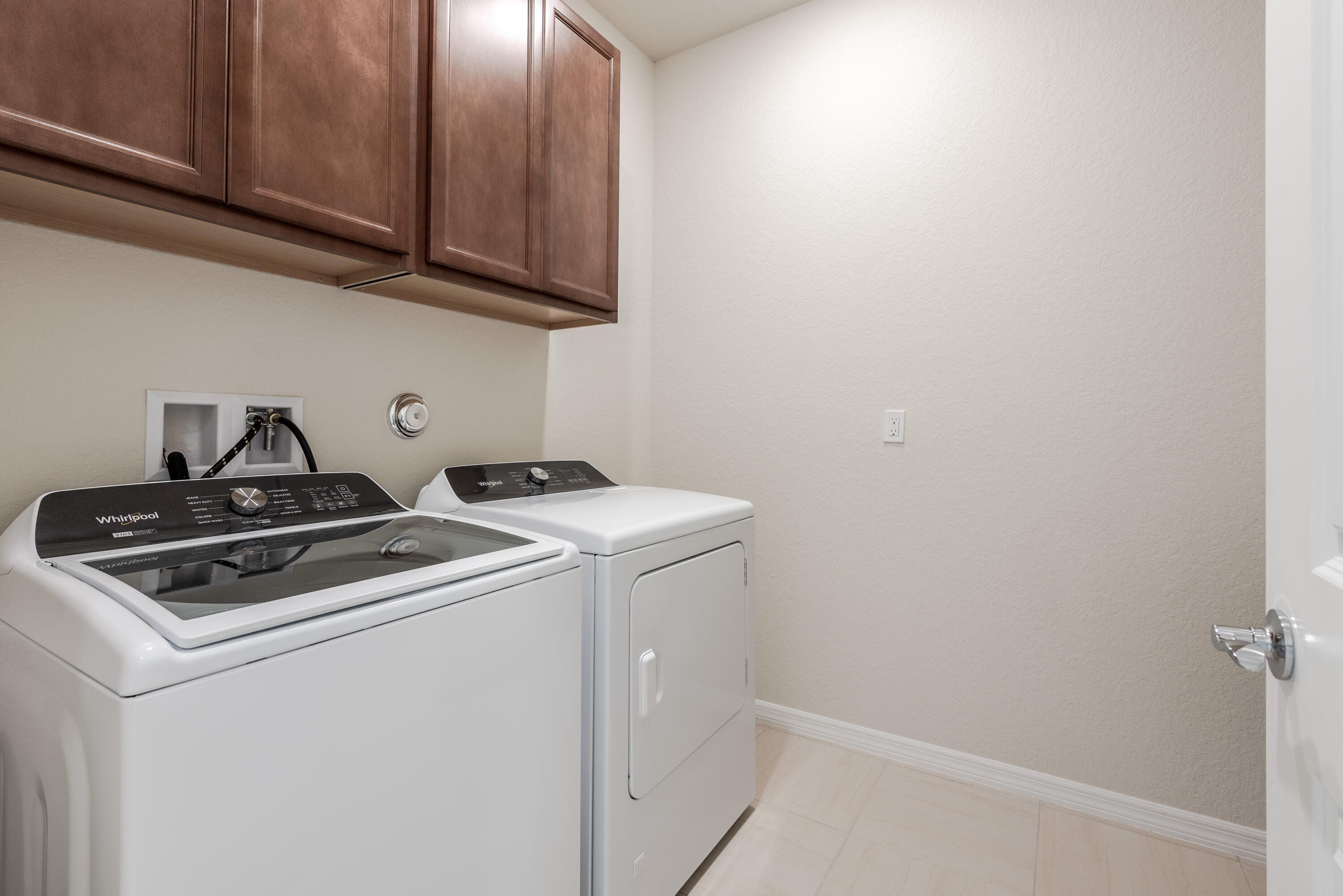 12327 Southwest Sand Dollar Way Port St. Lucie, FL 34987 - Photo 11 of 29 a view of storage and utility room with washer and dryer