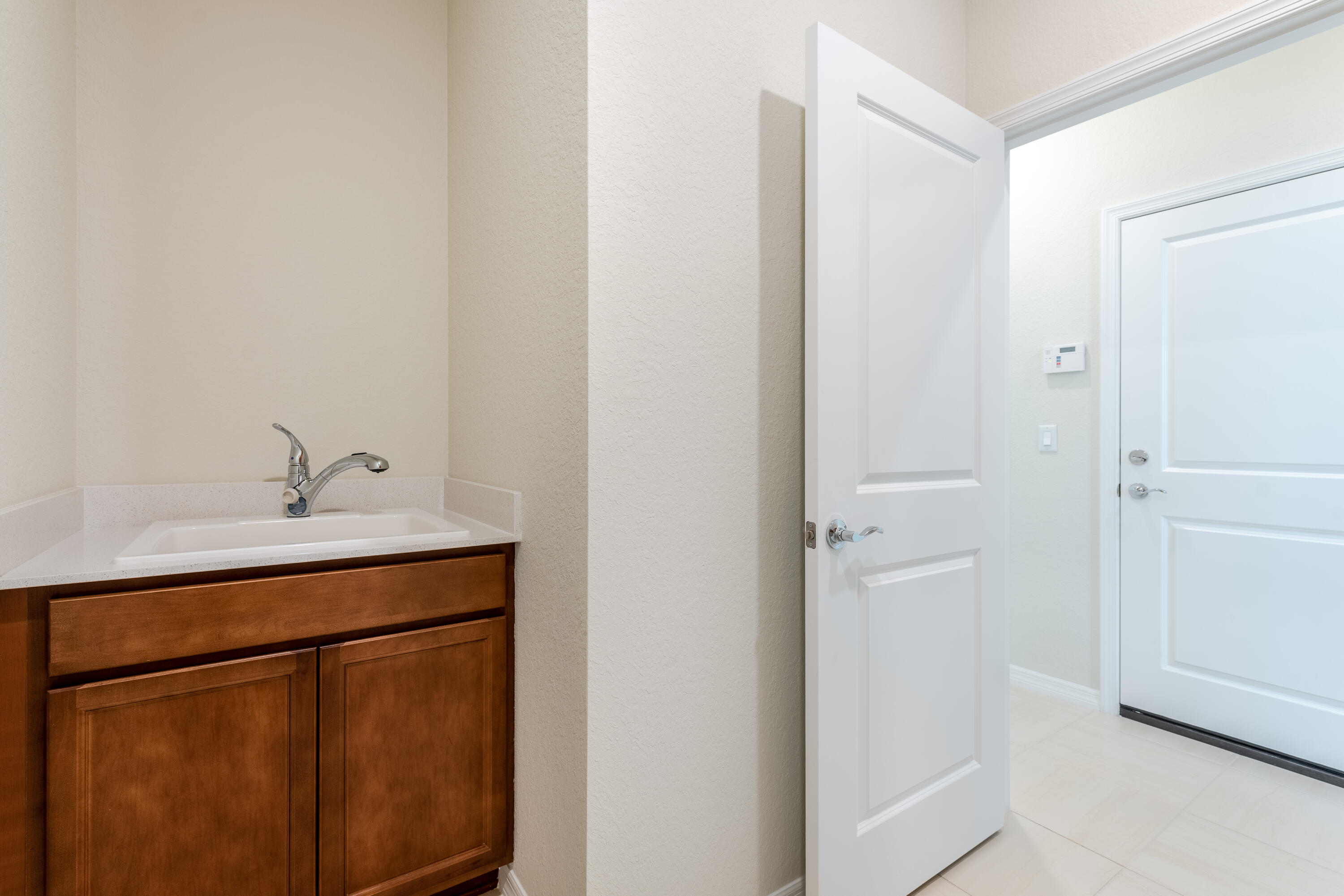 12327 Southwest Sand Dollar Way Port St. Lucie, FL 34987 - Photo 12 of 29 a bathroom with a sink vanity and a mirror