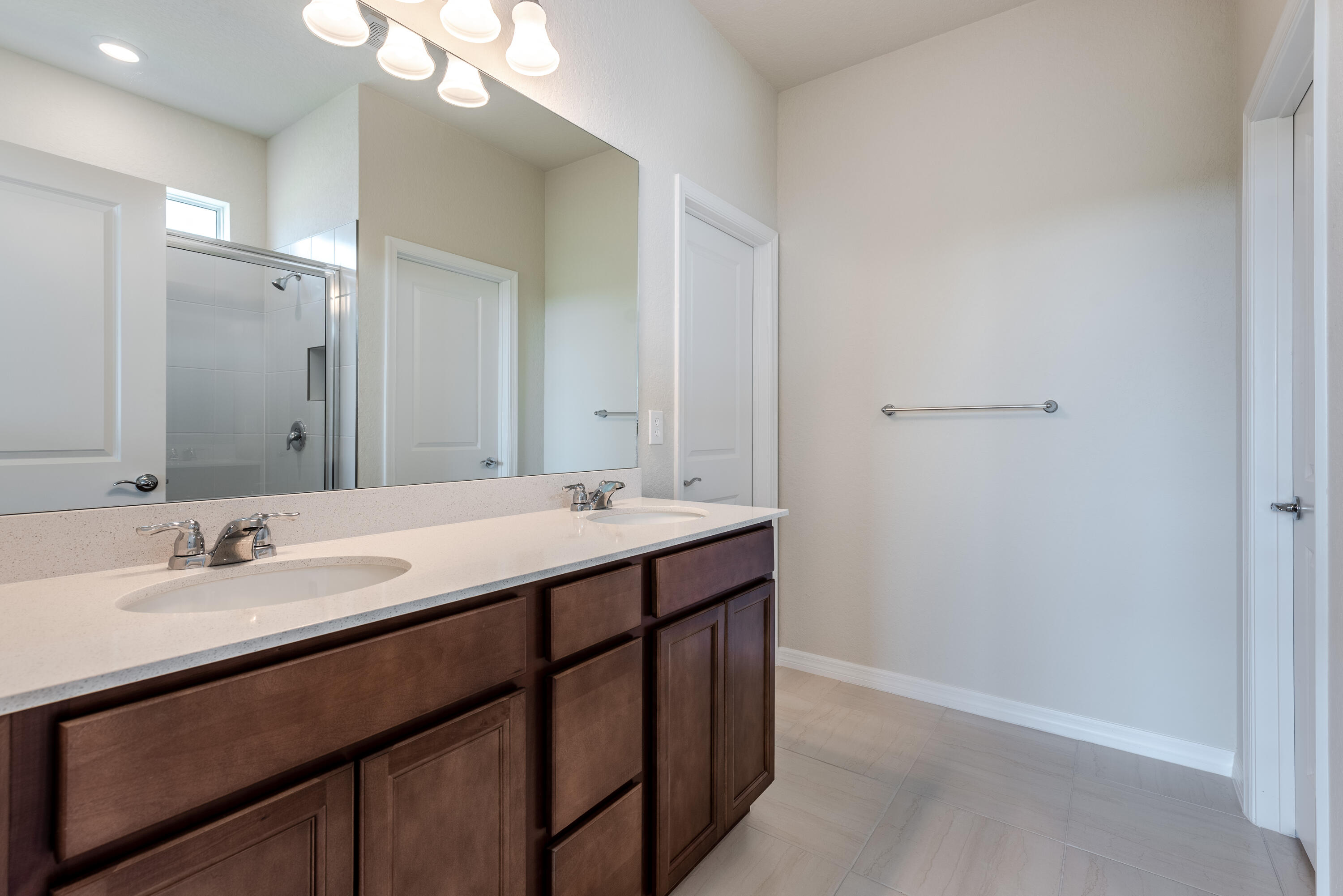 12327 Southwest Sand Dollar Way Port St. Lucie, FL 34987 - Photo 18 of 29 a bathroom with a double vanity sink and a mirror