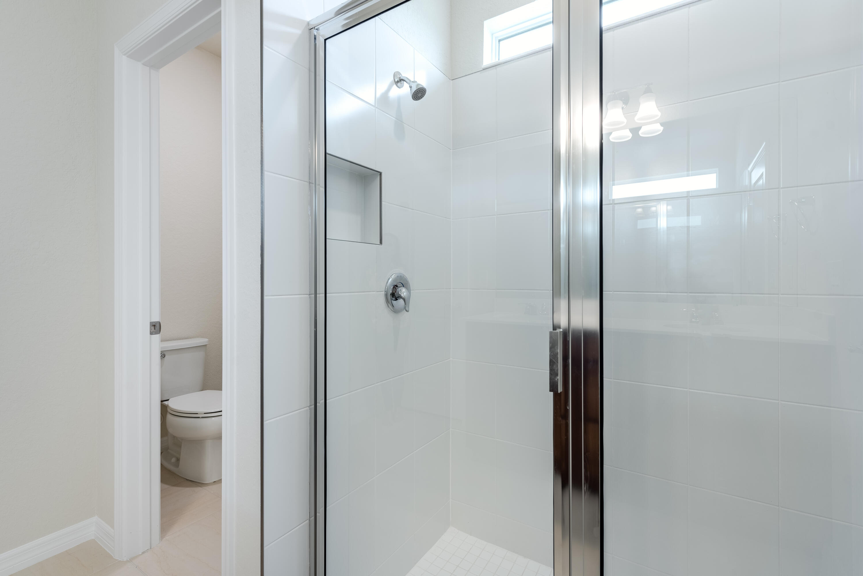 12327 Southwest Sand Dollar Way Port St. Lucie, FL 34987 - Photo 19 of 29 a bathroom with a glass shower door