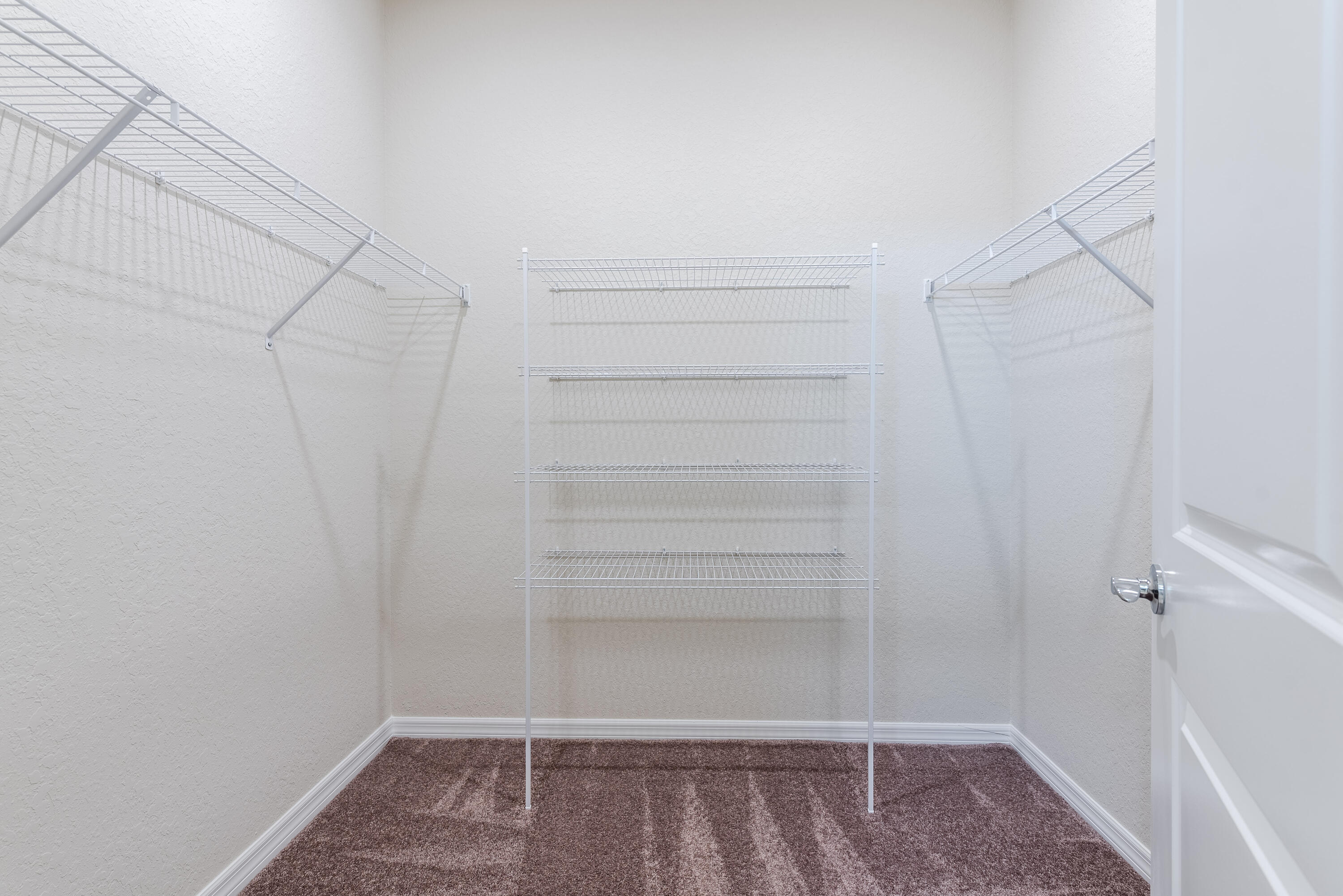 12327 Southwest Sand Dollar Way Port St. Lucie, FL 34987 - Photo 20 of 29 a view of walk in closet with empty racks