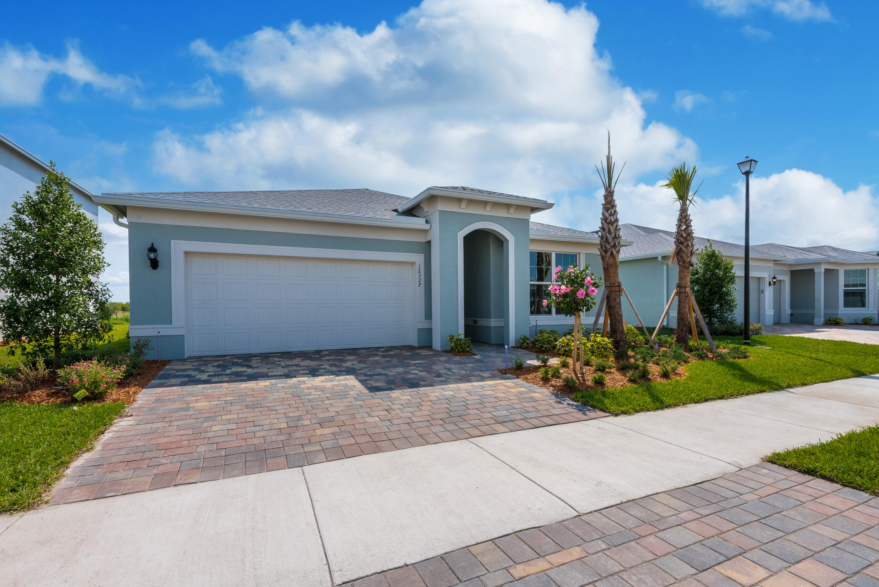 12327 Southwest Sand Dollar Way Port St. Lucie, FL 34987 - Photo 2 of 29 a front view of a house with garden